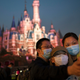 Guests take a photo in Shanghai Disneyland, a park where mask mandates have been largely successful.